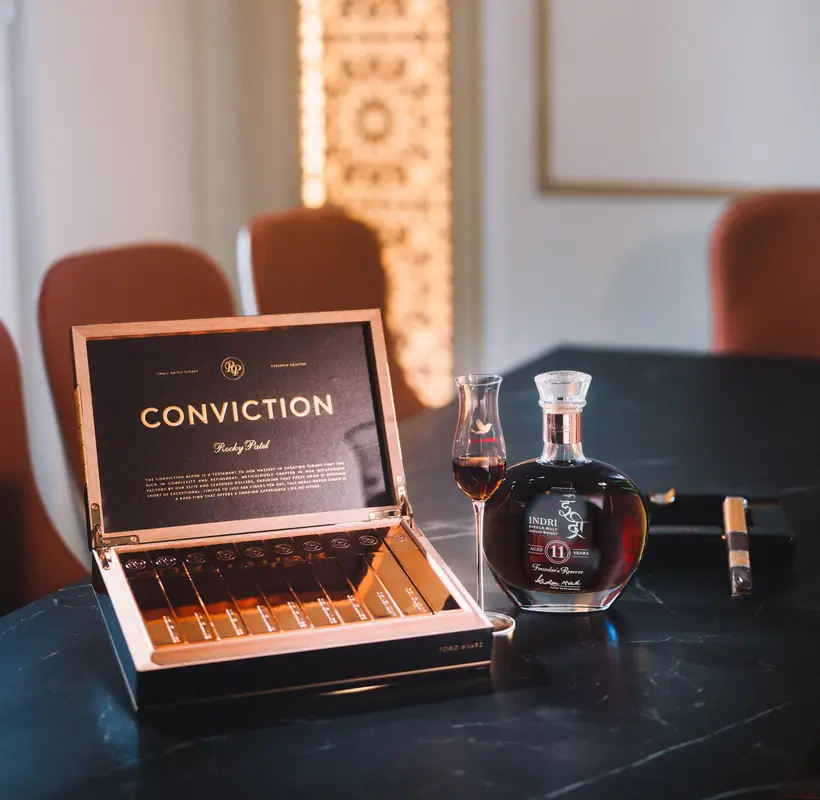 A Conviction cigar box and decanter on the lounge table