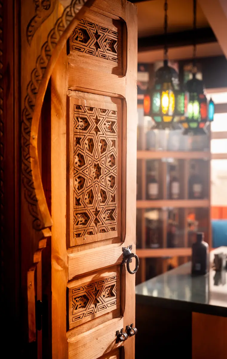The carved wooden door into the members' bar